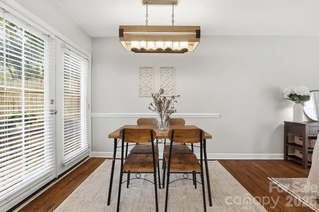 a view of a dining room with furniture and chandelier