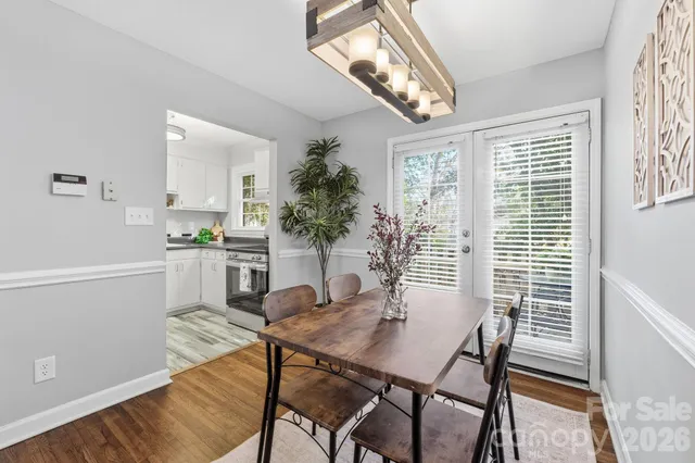a view of a dining room with furniture and a chandelier