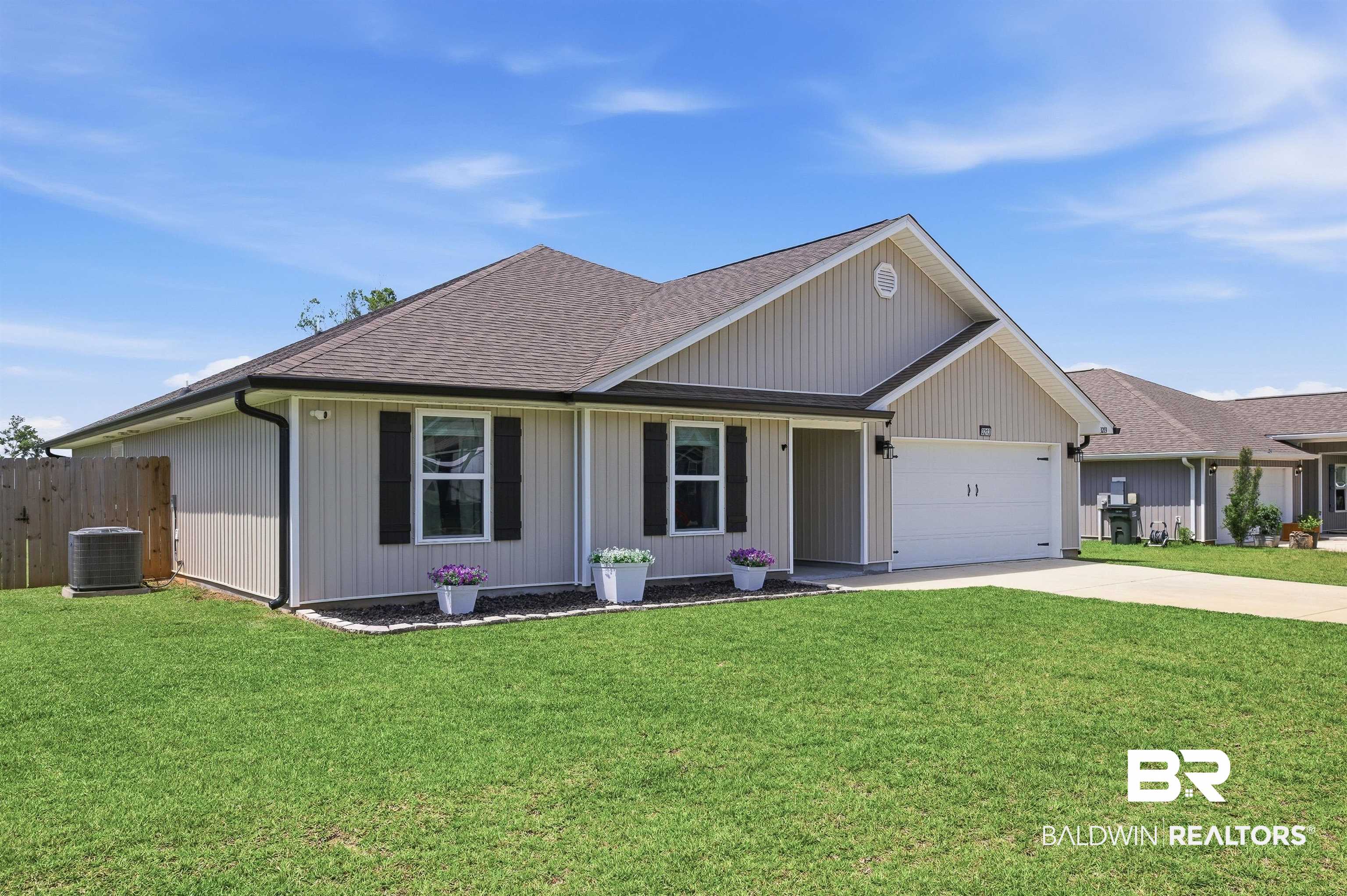 3213 Camino Real Loop Lillian, AL 36549 - Photo 2 of 61 Single-story residence featuring light-colored vertical siding and a dark shingle roof