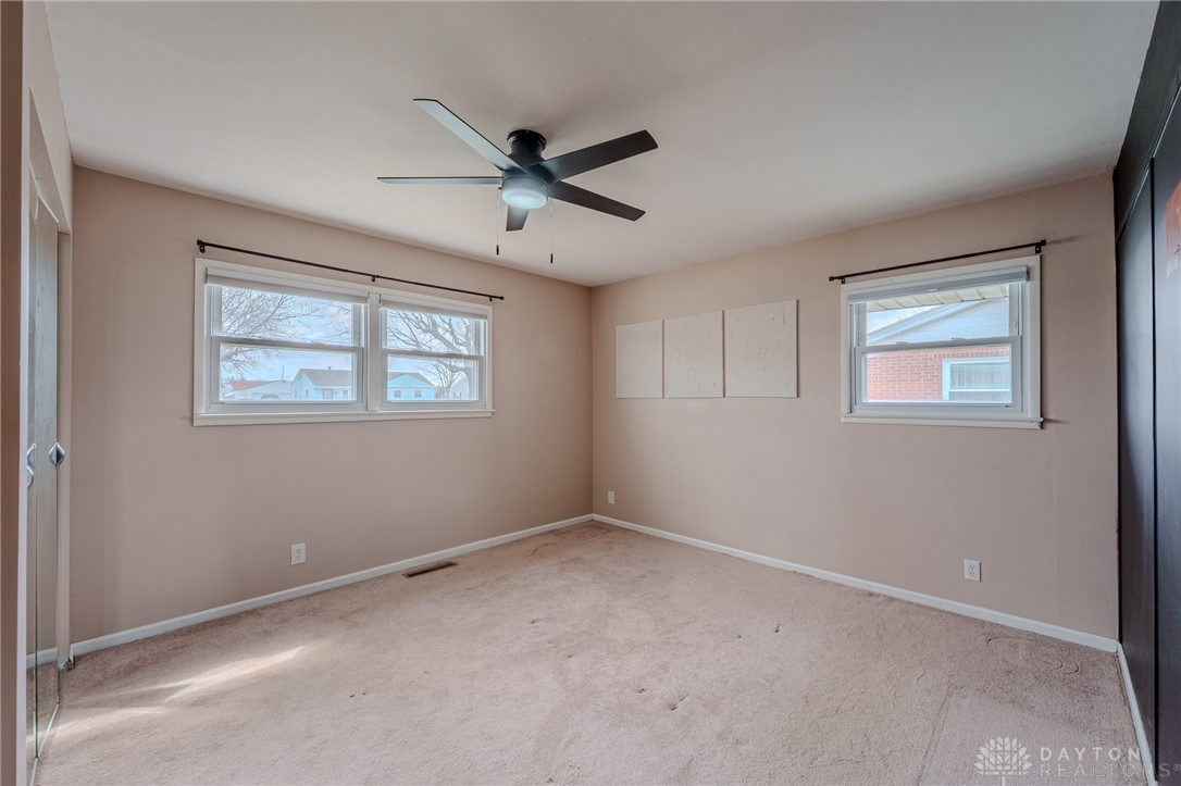 305 South Vandemark Road Sidney, OH 45365 - Photo 26 of 32 This primary bedroom offers generous space and abundant natural light through multiple windows.
