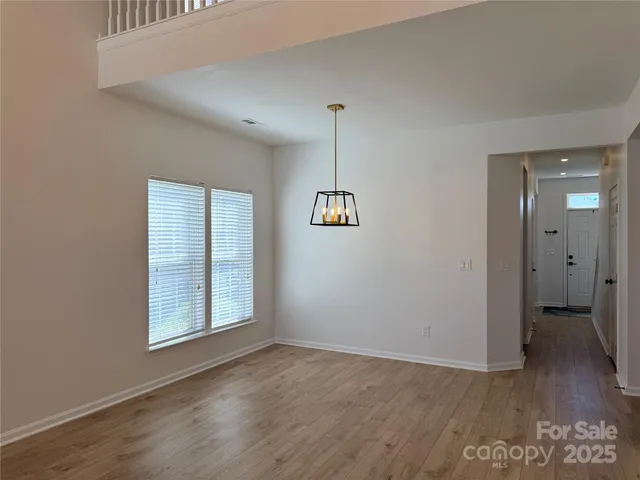 a view of an empty room with a window and fireplace