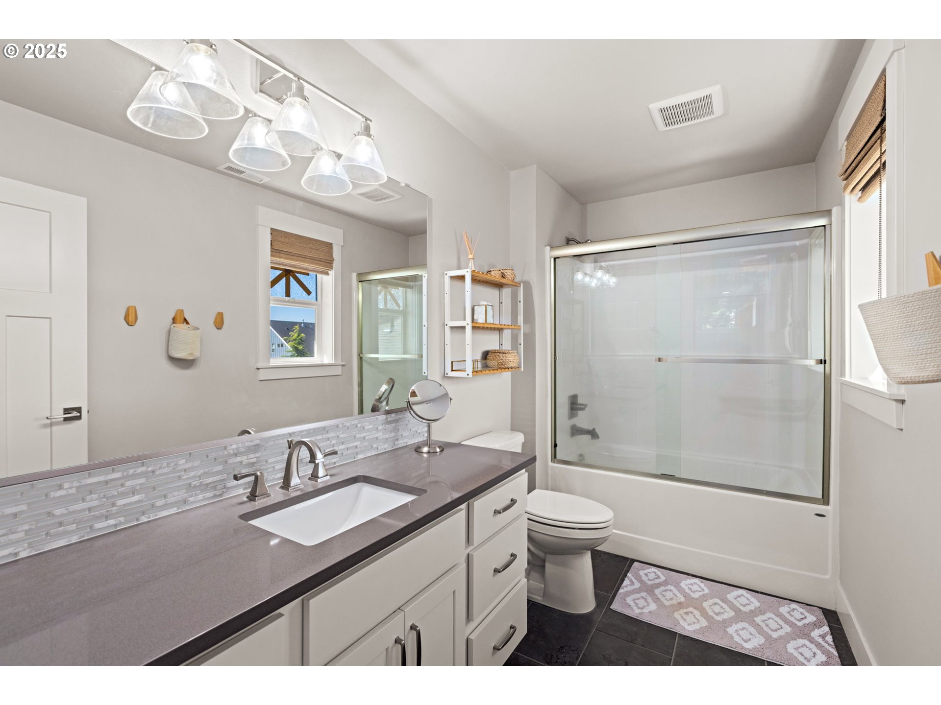 36904 Salmonberry Avenue Sandy, OR 97055 - Photo 24 of 44 a bathroom with a granite countertop sink a toilet a mirror a vanity and shower