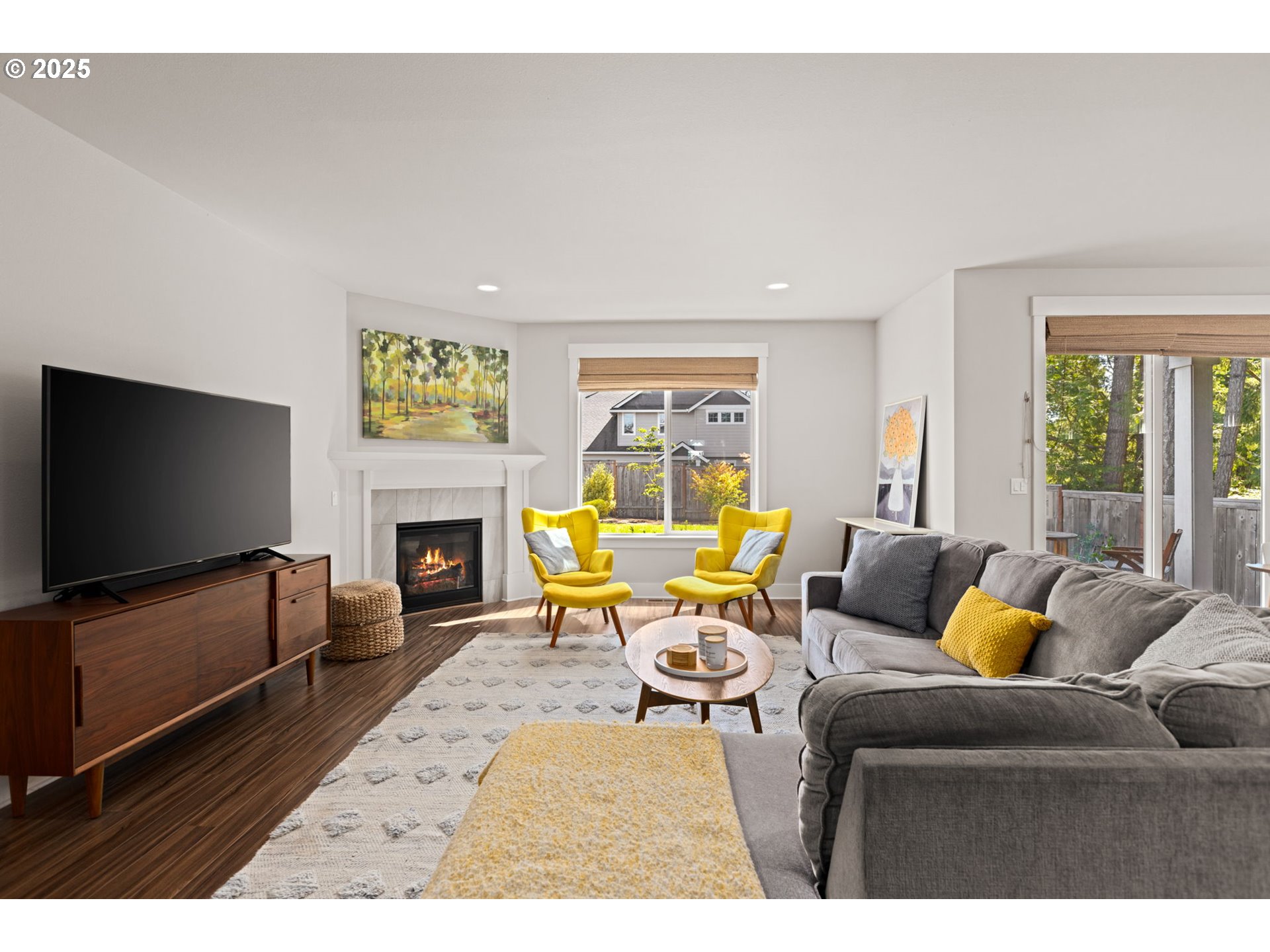 36904 Salmonberry Avenue Sandy, OR 97055 - Photo 3 of 44 a living room with furniture a flat screen tv and a fireplace
