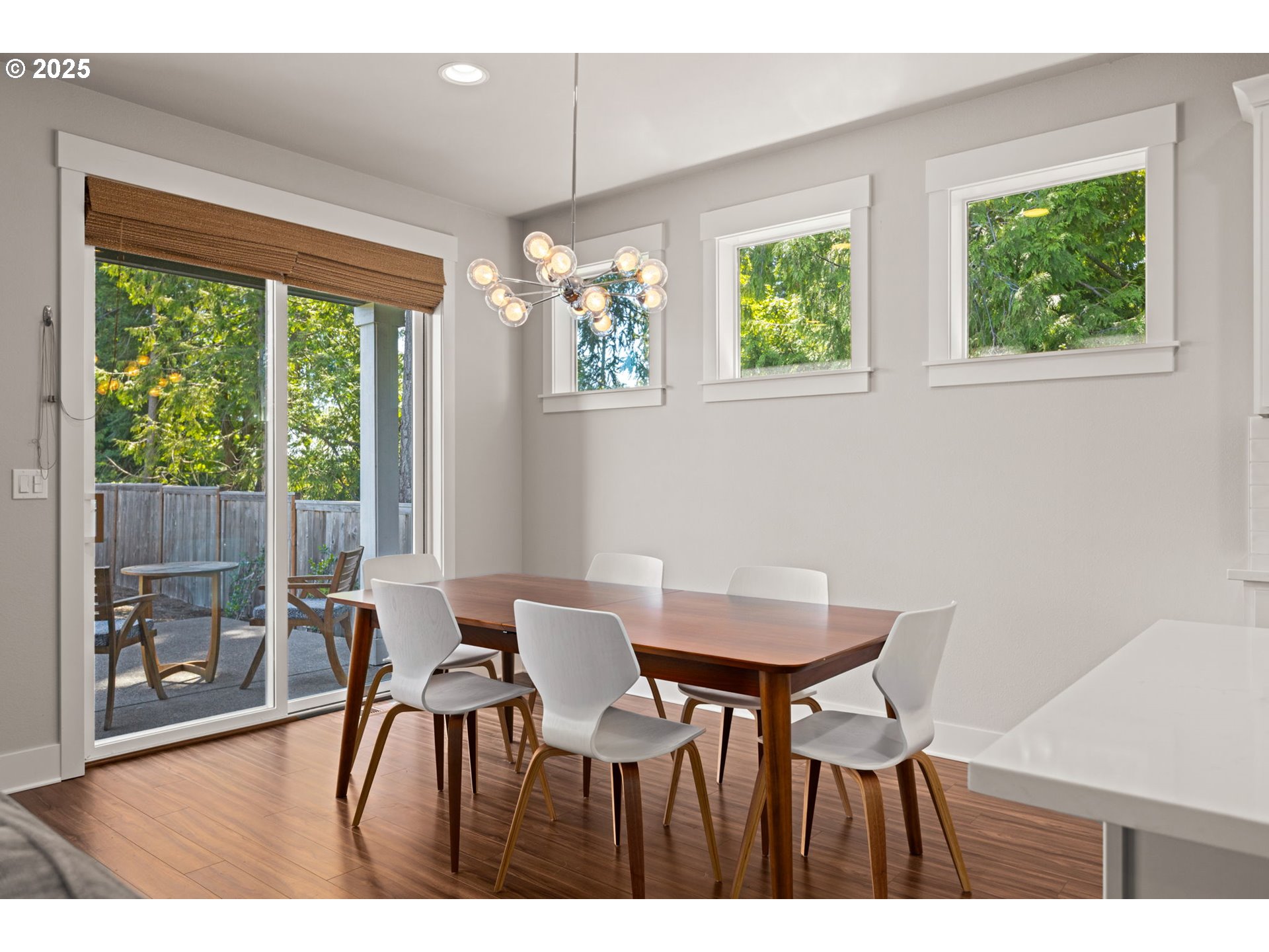 36904 Salmonberry Avenue Sandy, OR 97055 - Photo 6 of 44 a view of a dining room with furniture a chandelier and wooden floor