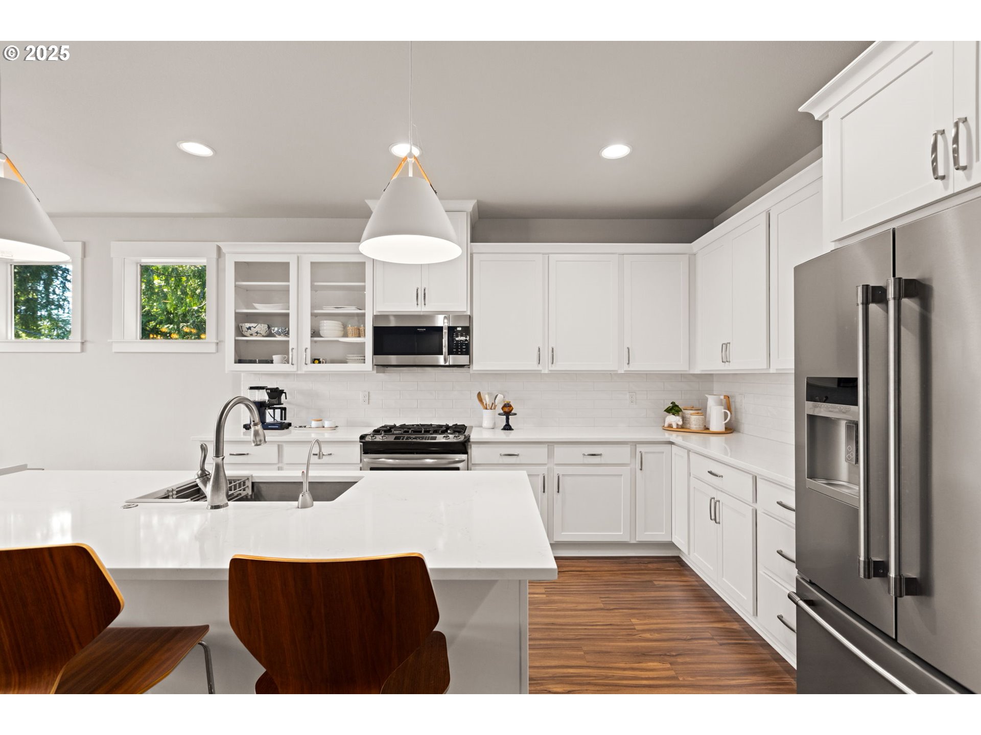 36904 Salmonberry Avenue Sandy, OR 97055 - Photo 8 of 44 a kitchen with stainless steel appliances a sink a stove a refrigerator cabinets and a window
