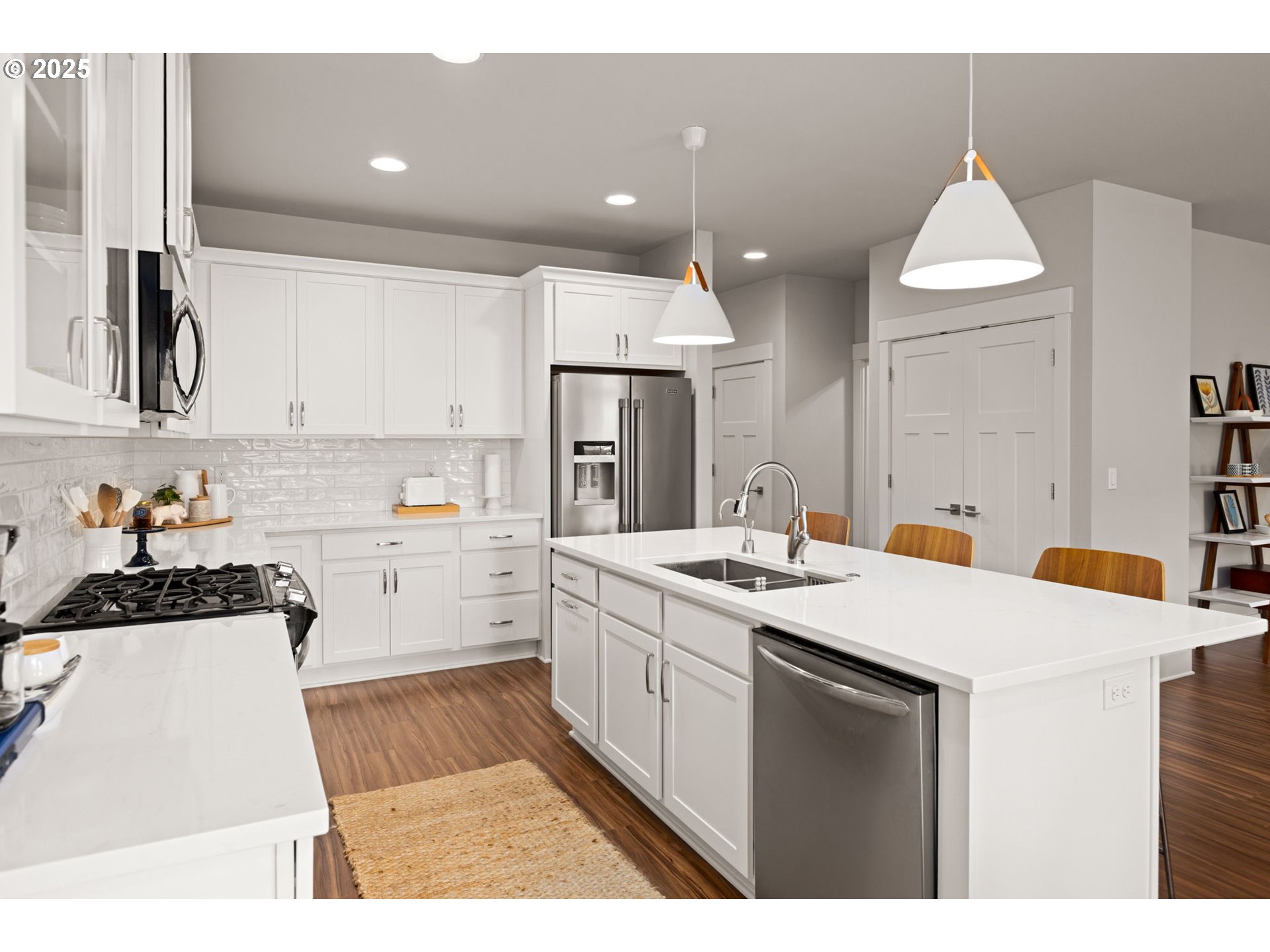 36904 Salmonberry Avenue Sandy, OR 97055 - Photo 9 of 44 a kitchen with a sink a stove a refrigerator and white cabinets