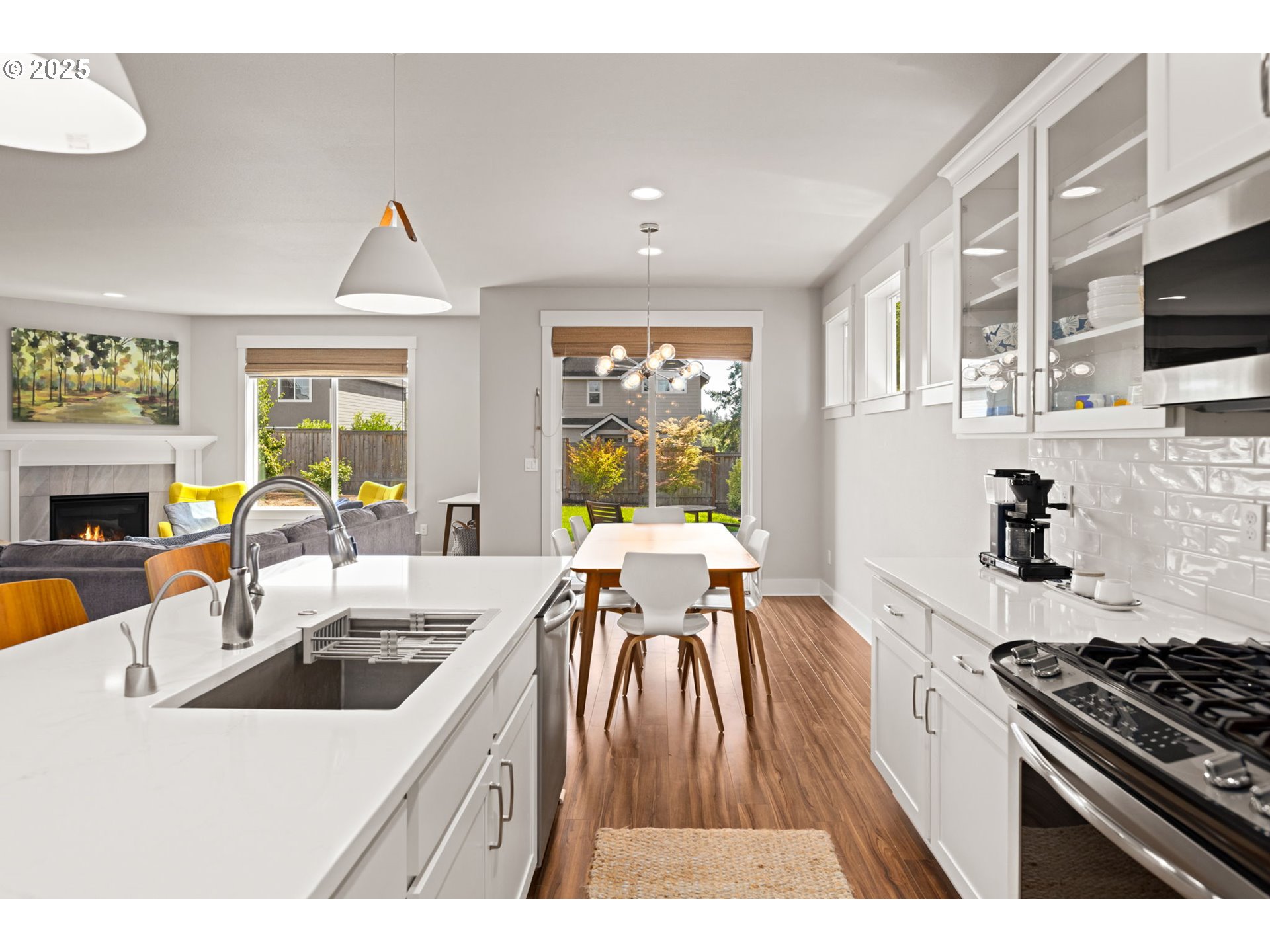 36904 Salmonberry Avenue Sandy, OR 97055 - Photo 10 of 44 a kitchen with stainless steel appliances granite countertop a stove a sink dishwasher and a microwave with wooden floor