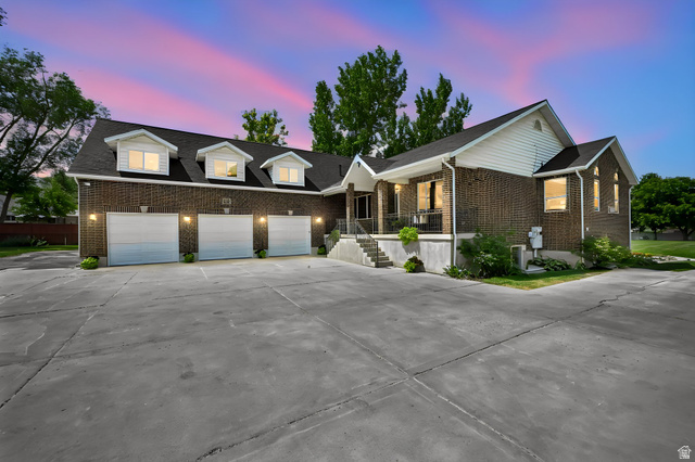 13658 South Fort Street Draper, UT 84020 - Photo 86 of 87 Brick exterior featuring a three-car garage with dormer windows above