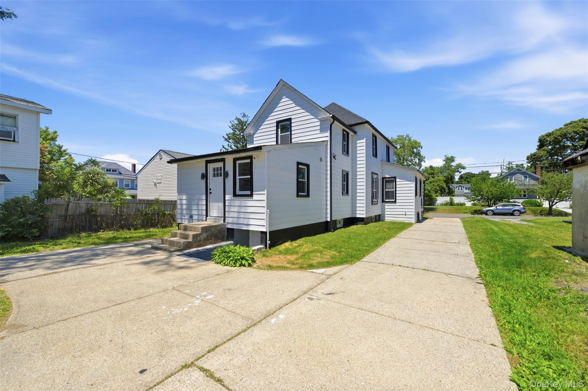 135 Whaley Street Freeport, NY 11520 - Photo 38 of 38 a front view of a house with a yard and garage