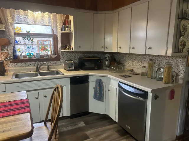 a kitchen with a sink stove and cabinets