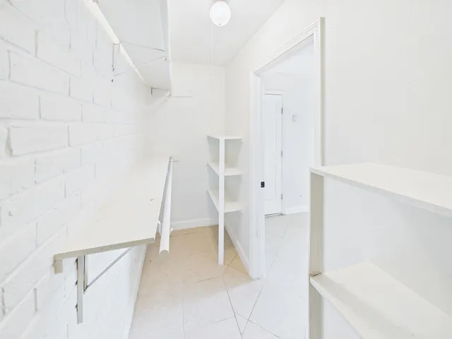 a view of an empty room with white walls