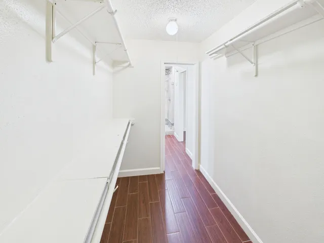 a hallway of a house with wooden floor