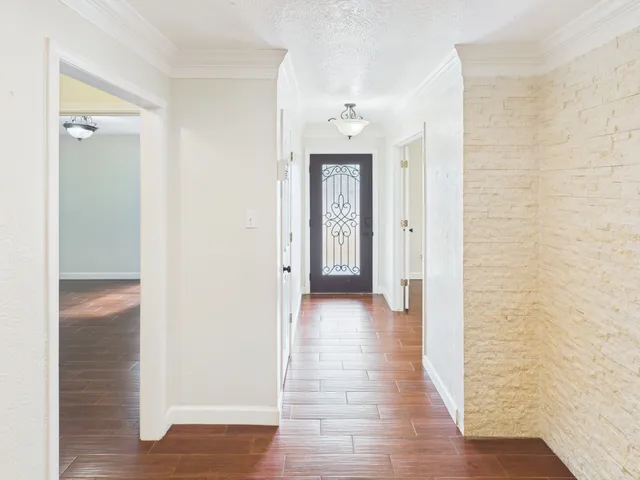 a view of a hallway with wooden floor