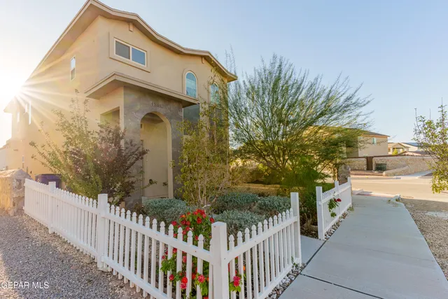 a front view of a house with trees