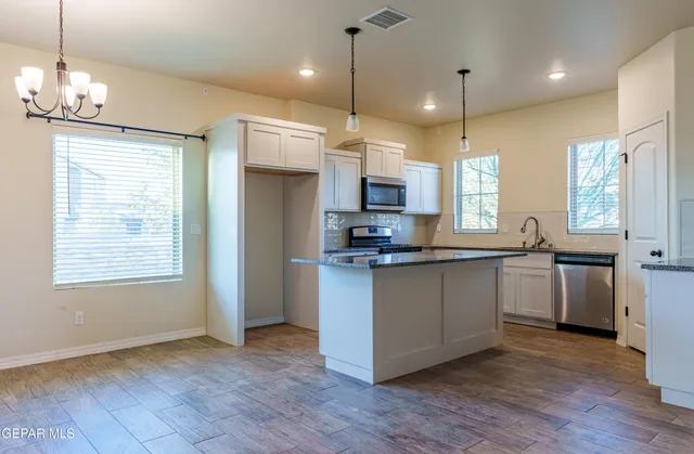 a large kitchen with a lot of counter space and a refrigerator