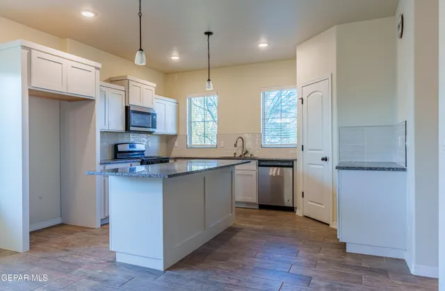 a kitchen with sink cabinets and window