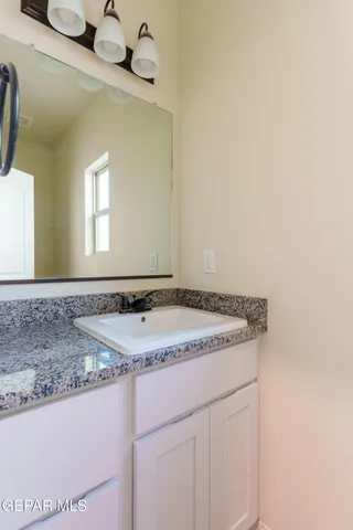 a view of a livingroom with a window and a ceiling fan