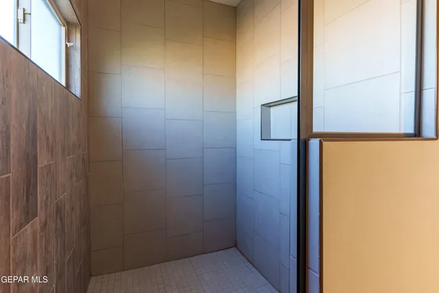 an empty room with a ceiling fan and a window