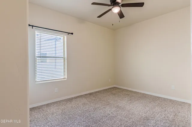 a view of a terrace with lawn chairs