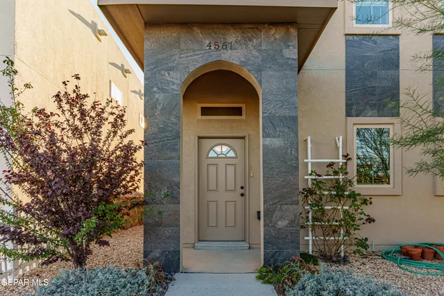 a view of a room with wooden floor and a chandelier