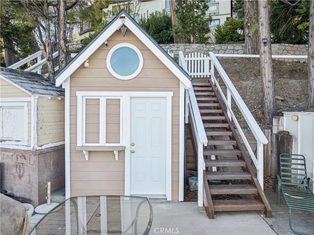 a view of a roof deck with a couch and wooden floor