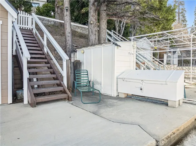 a view of a roof deck with couches and wooden floor
