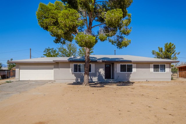 13356 Tutelo Road Apple Valley, CA 92308 - Photo 1 of 1 a view of a house with a backyard