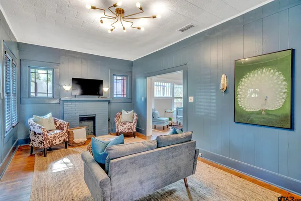 a living room with furniture and a fireplace