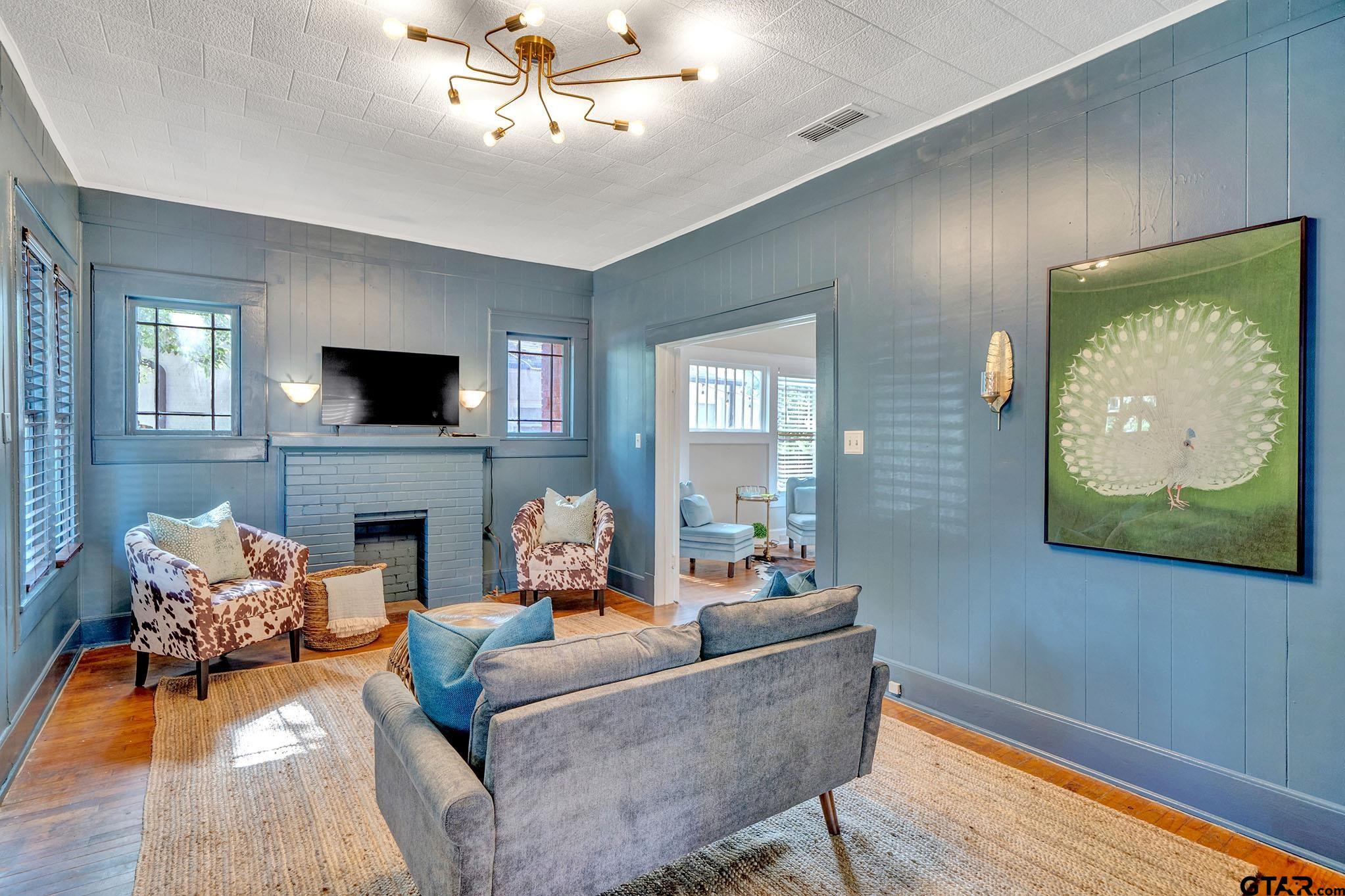 301 West Houston Street Tyler, TX 75702 - Photo 14 of 18 a living room with furniture and a fireplace