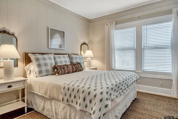 a bedroom with a bed and a night stand