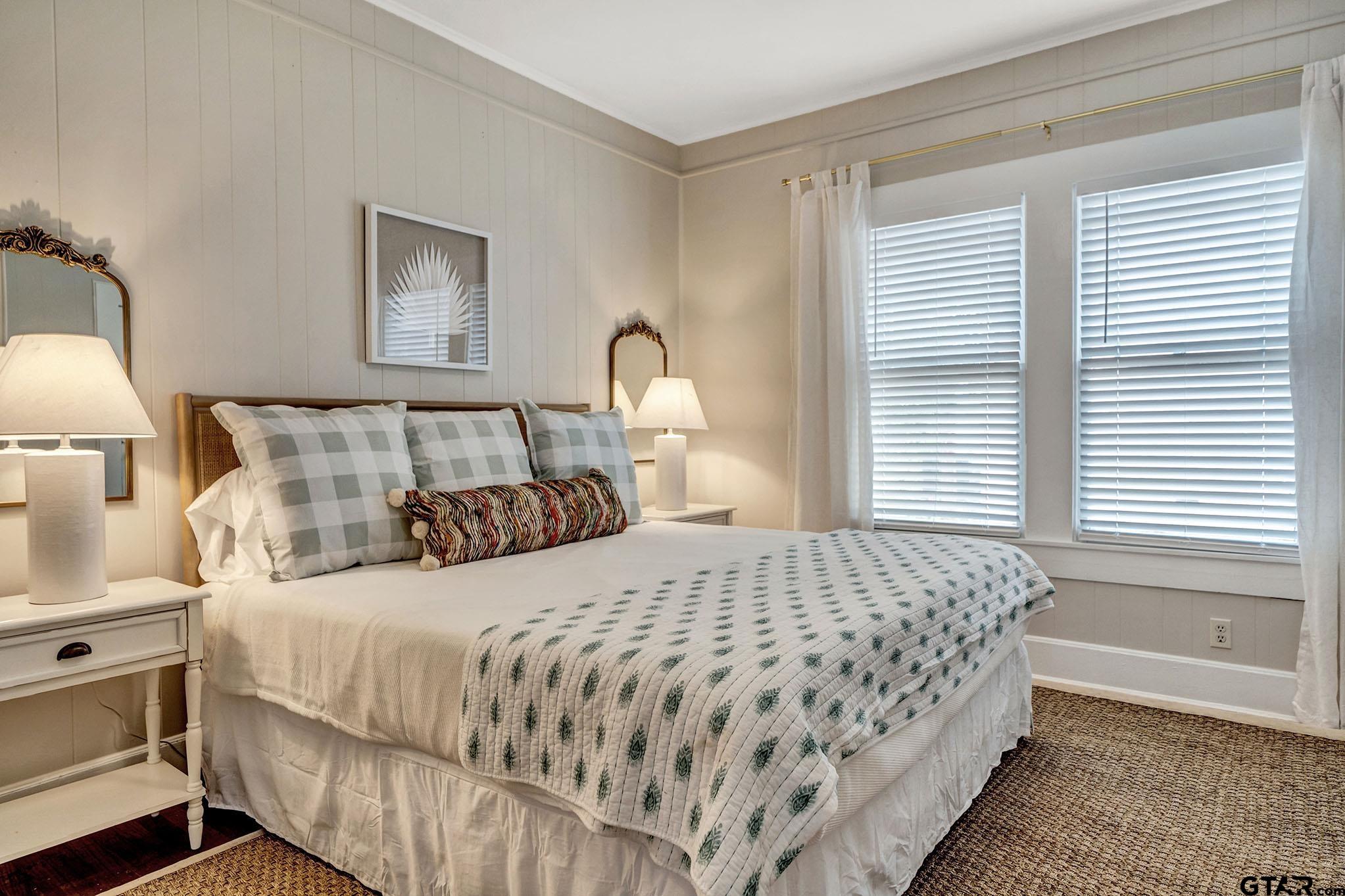 301 West Houston Street Tyler, TX 75702 - Photo 17 of 18 a bedroom with a bed and a night stand