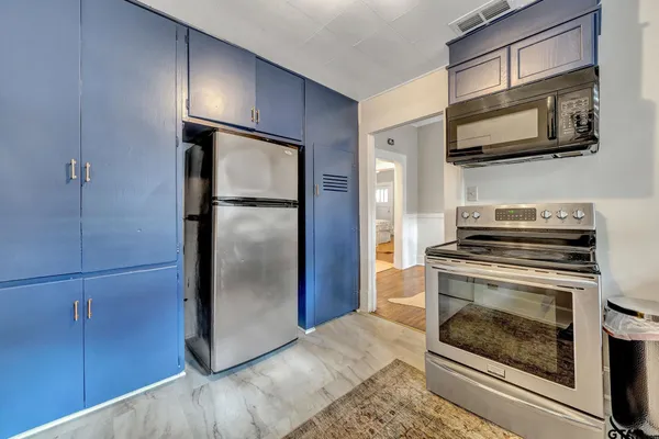 a kitchen with a refrigerator stove and microwave
