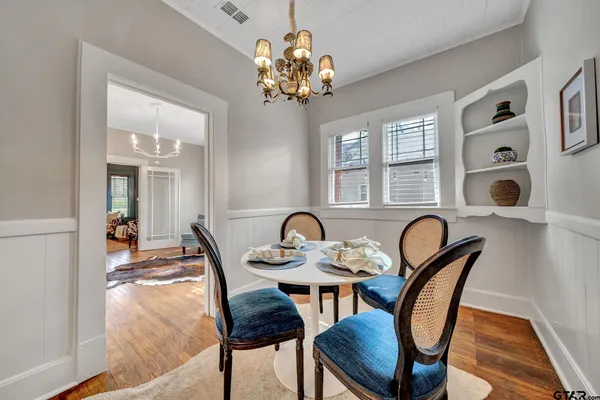 a dining room with furniture and chandelier