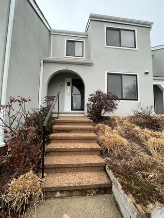 a view of a hallway with wooden floor and cabinet