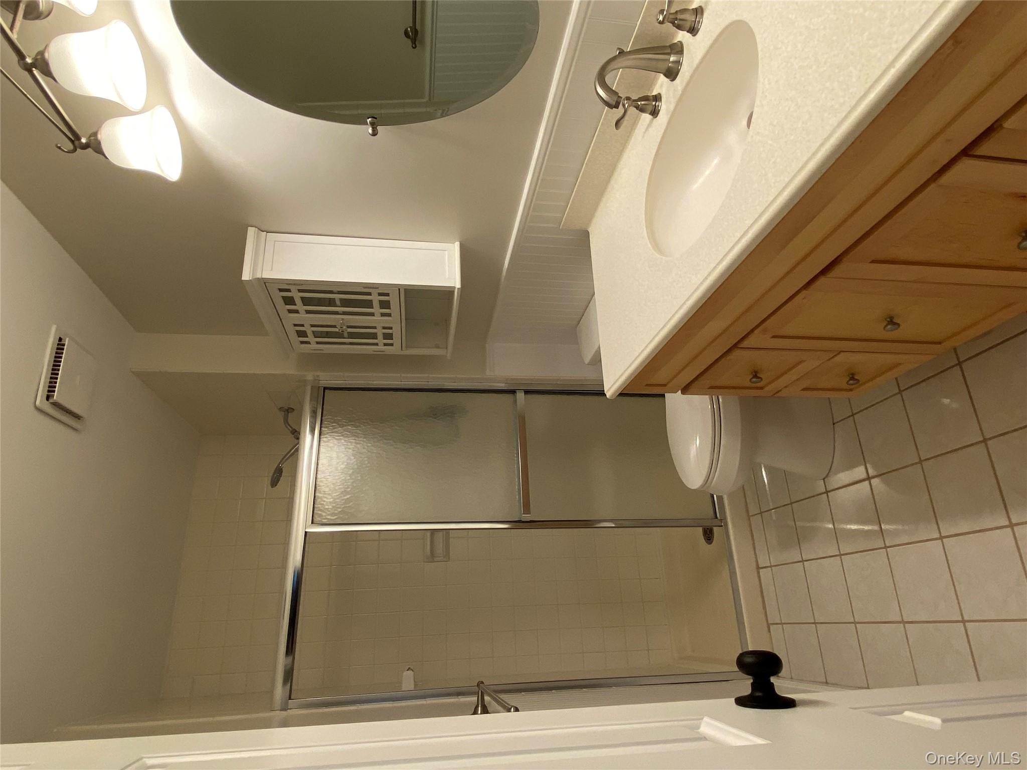 11 Wildwood Road, Unit 12 Katonah, NY 10536 - Photo 11 of 17 a bathroom with a sink toilet and shower