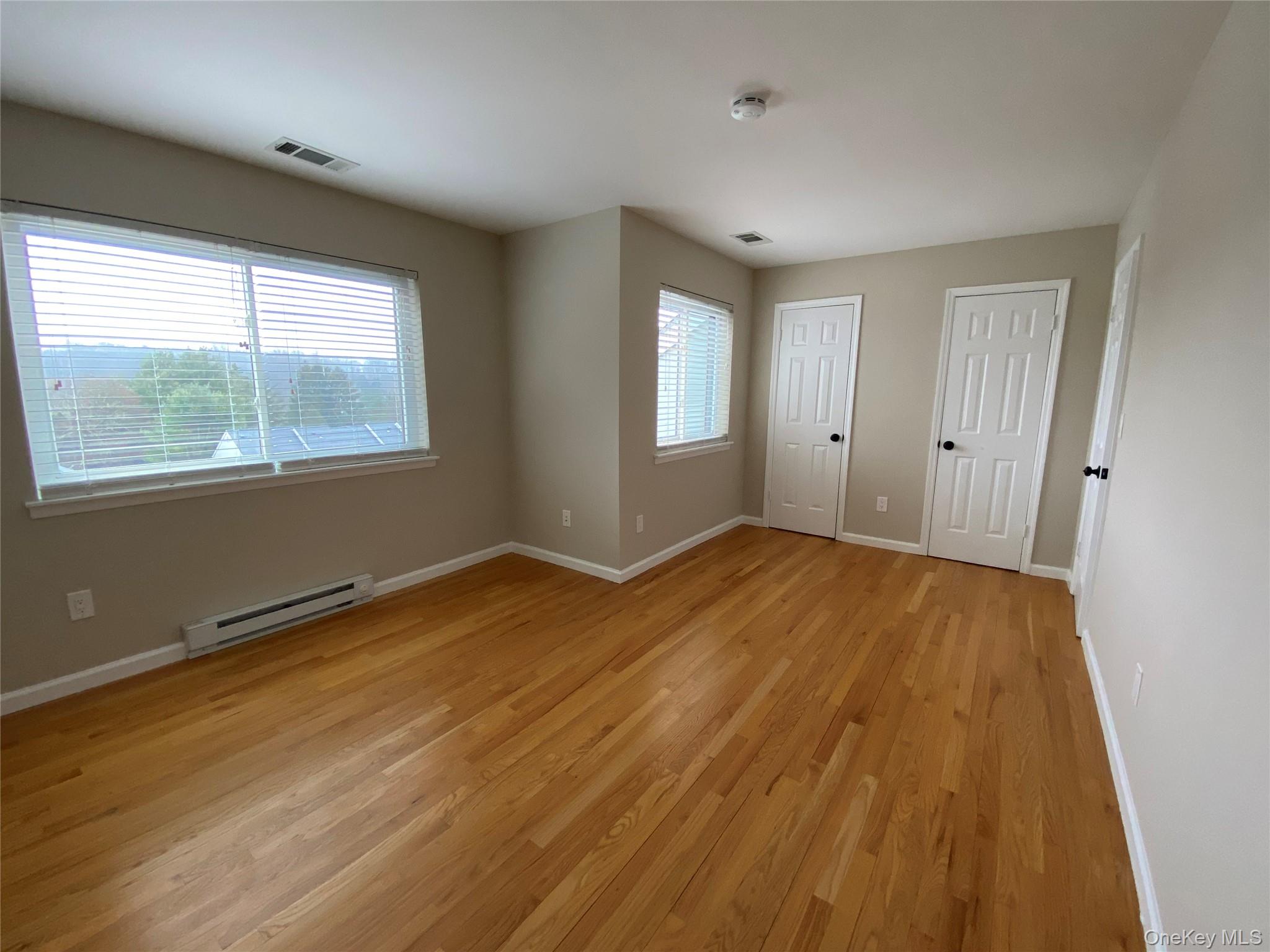 11 Wildwood Road, Unit 12 Katonah, NY 10536 - Photo 13 of 17 a view of an empty room with wooden floor and a window