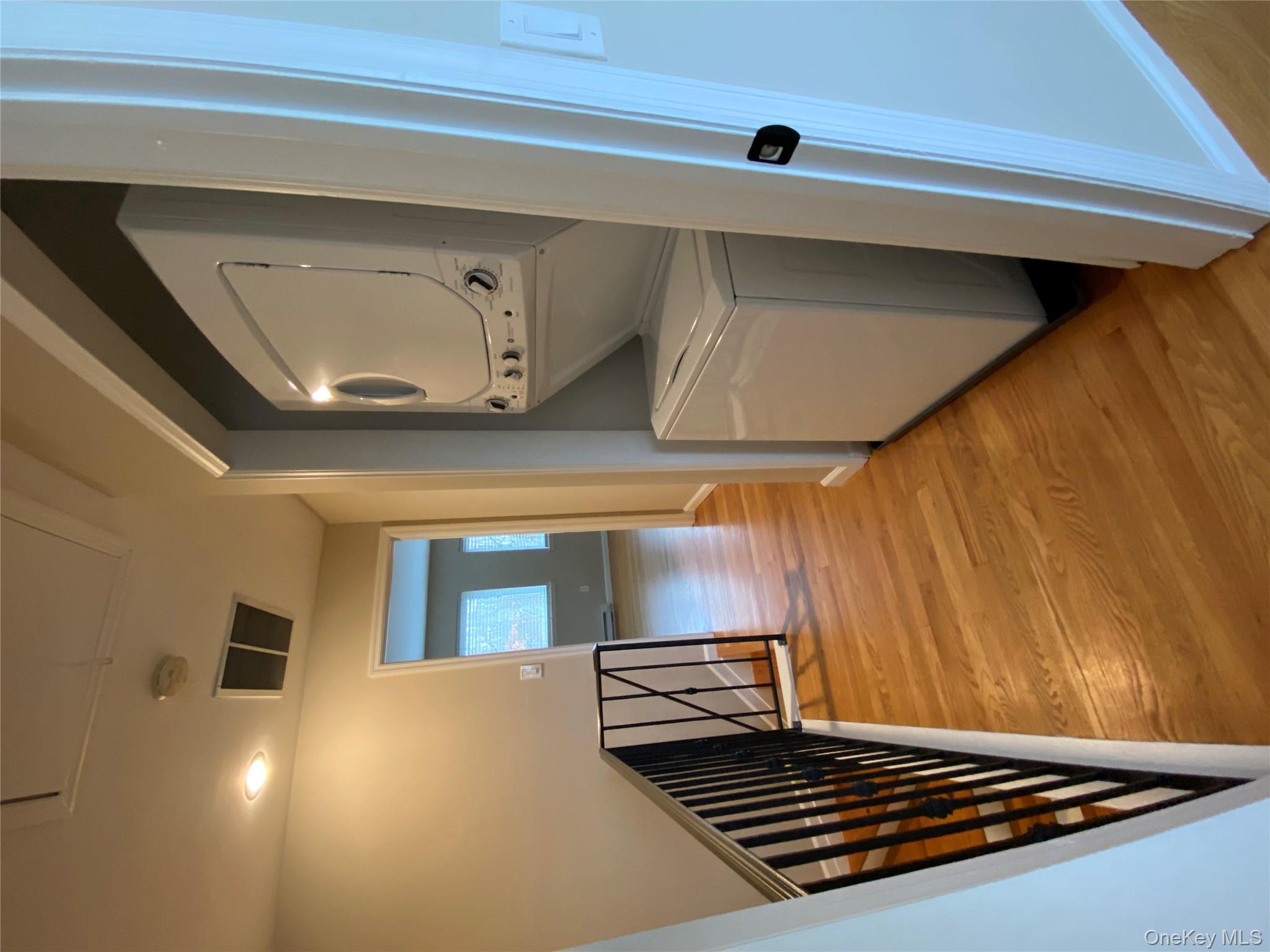 11 Wildwood Road, Unit 12 Katonah, NY 10536 - Photo 16 of 17 a view of a hallway with wooden floor and staircase
