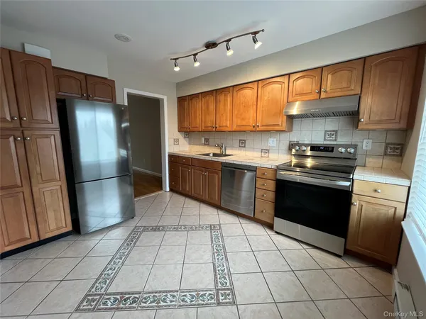 a kitchen with a stove sink and cabinets