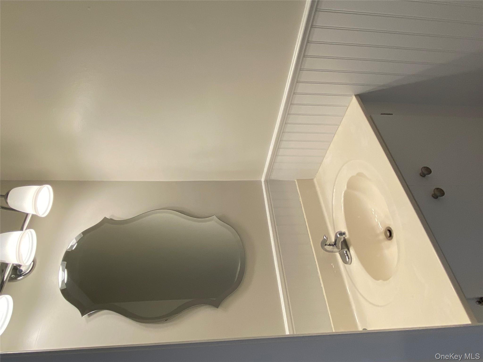 11 Wildwood Road, Unit 12 Katonah, NY 10536 - Photo 8 of 17 a bathroom with a sink vanity and a mirror