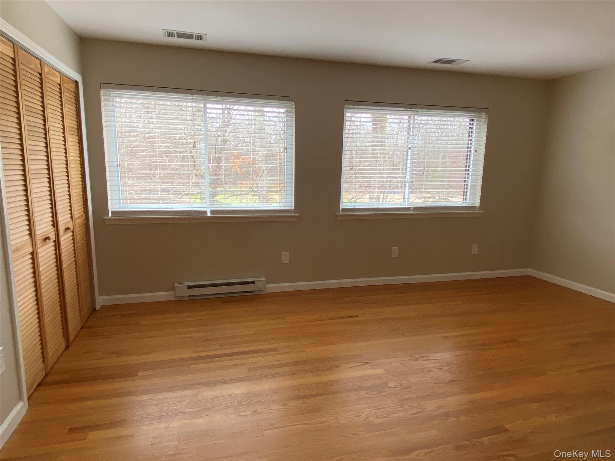 11 Wildwood Road, Unit 12 Katonah, NY 10536 - Photo 9 of 17 a view of an empty room with wooden floor and a window