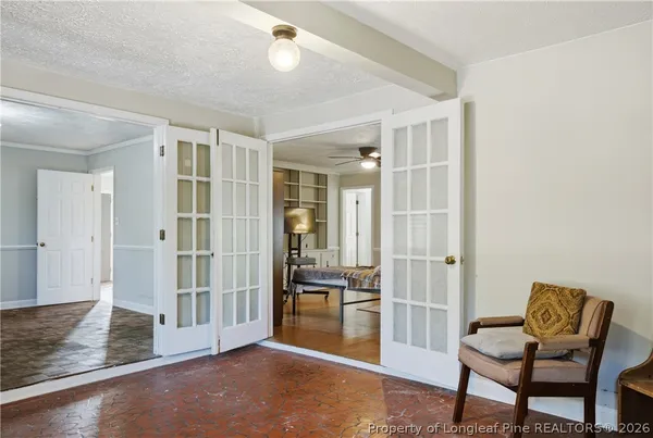 a view of a hallway with entryway and livingroom with furniture