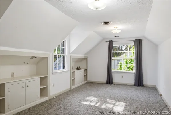an empty room with windows and entrance