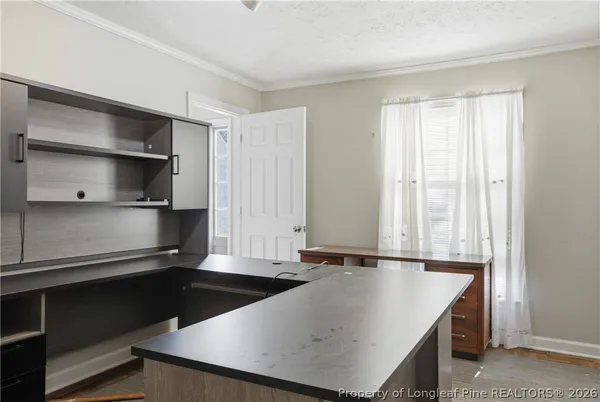 a kitchen with a sink a microwave and cabinets