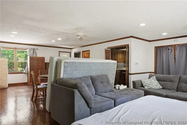 a living room with furniture and wooden floor