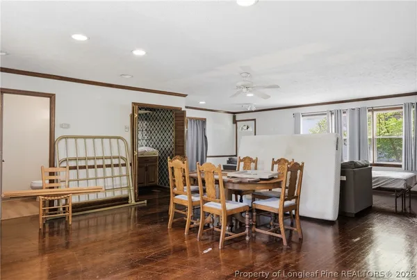 a view of a dining room with furniture and wooden floor