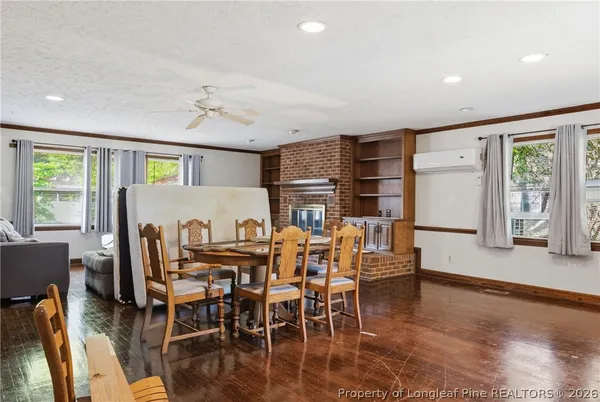 a dining room with furniture window and wooden floor