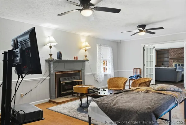a living room with furniture a fireplace and a flat screen tv