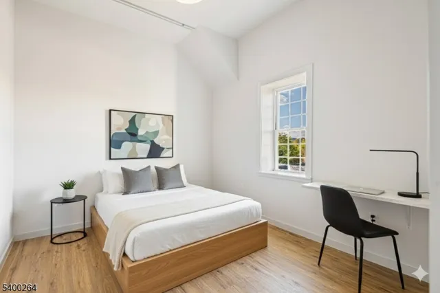 a bedroom with a bed and a lamp on table