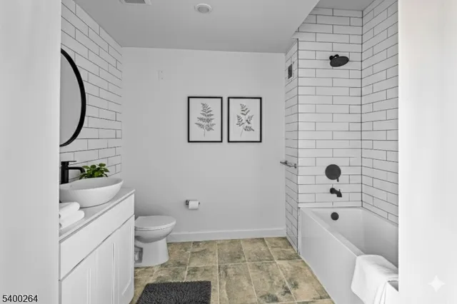 a bathroom with a bathtub sink and toilet