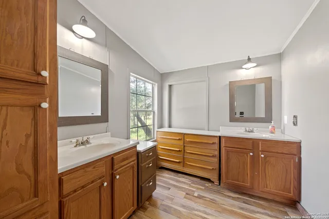 a bathroom with a double vanity sink mirror and